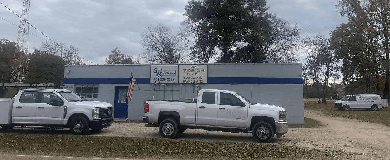 G & R Services building with branded trucks and American flag